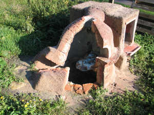 The band of bare soil around the furnace caused by heat sterilisation.