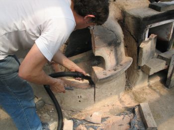 13. Vacuuming the tank furnace.