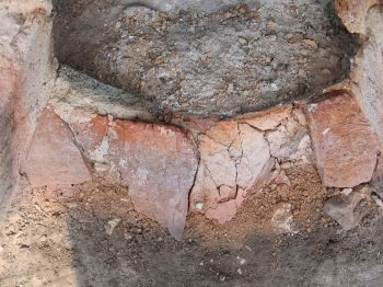 22. The top layer of tiles under the fired furnace wall.