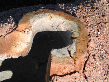 37. Detail of the top of the furnace, showing the cracks, caused by frost action, dividing loose areas of daub.