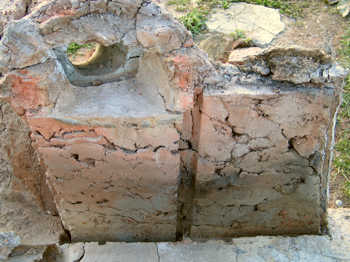 21. The wall of the oven with the tile lining removed.