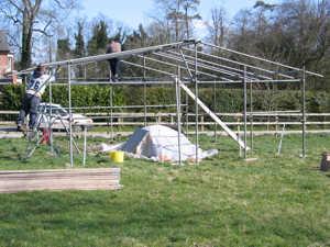 The new shelter under construction. The pot furnace is under the plastic sheeting.