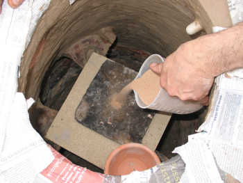 8. Making the bed of sand for the large pot.