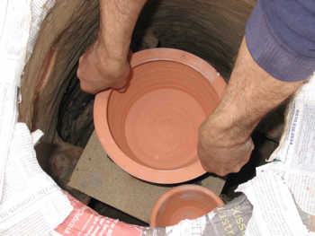 9. Setting the large pot in position.