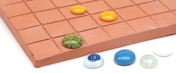 Counters on a terracotta tile