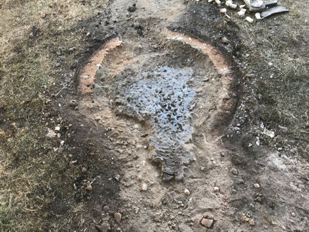 The cleaned furnace footprint showing the pool of leaked glass