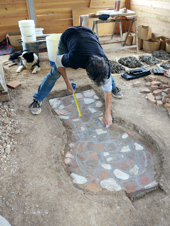 Sketching the outline of the firepit floor on the tiles