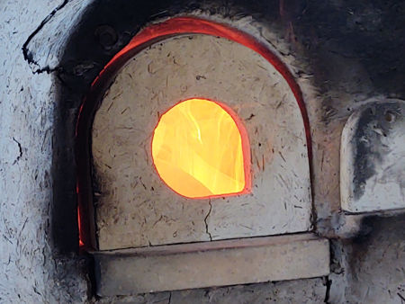 Three hours into the firing: flames around the pots