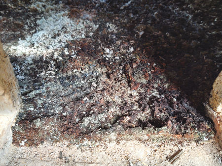 Firing Three: red-brown ash at the back of the furnacee - at the ash-removal hole