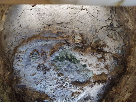The build-up of glass and ash in the firepit