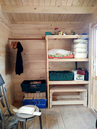 The first set of shelves in the shed