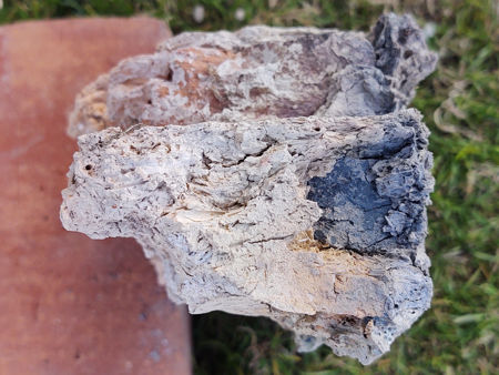 A cross-section through part of the firepit wall, showing tiles and fired daub