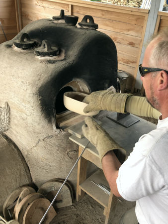 Removing a broken pot before firing the furnace (Photo © Fiona Rashleigh)