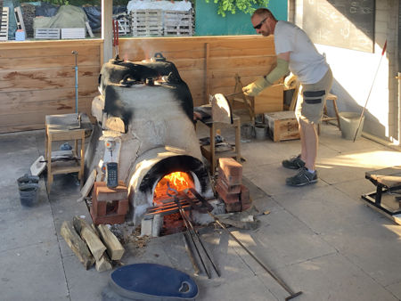 Using the stoke hole to keep the tongs warm (Photo © Fiona Rashleigh)