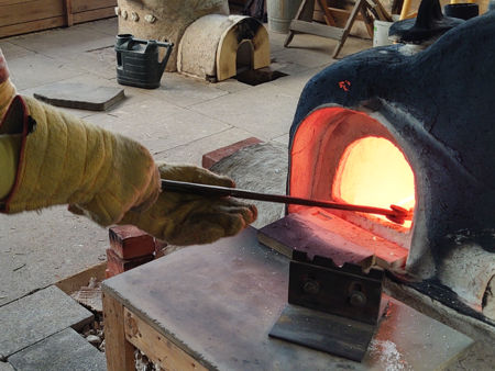 Removing a pot from the furnace